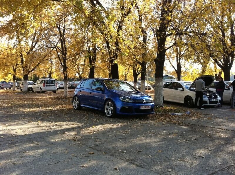 Blue car in autumn parking lot