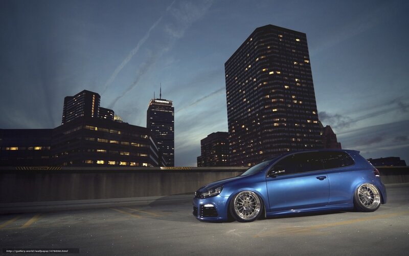 Blue car in city at dusk