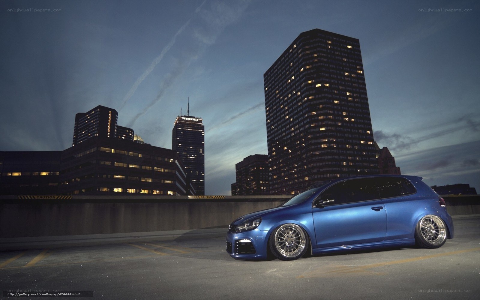 Blue car in city at dusk
