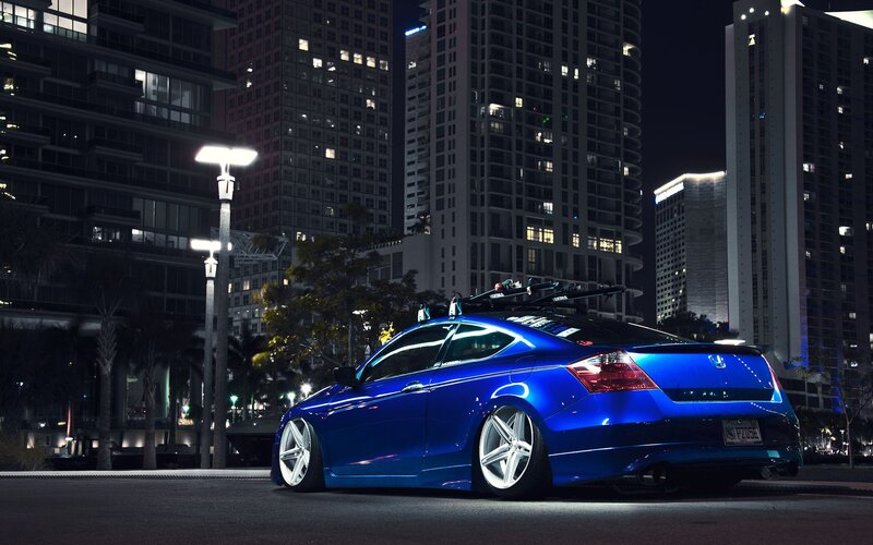 blue car in city at night