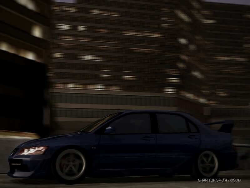 blue car in city at night