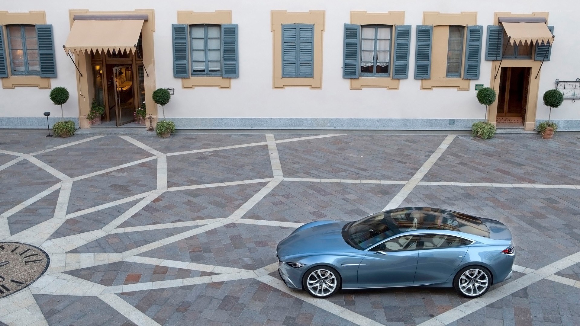 Blue car in courtyard