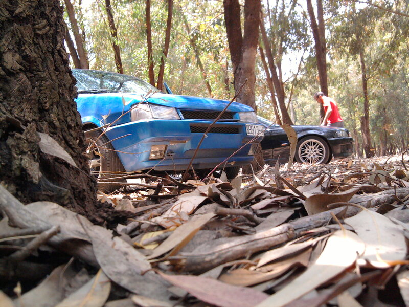 Blue Car in Forest — Natural