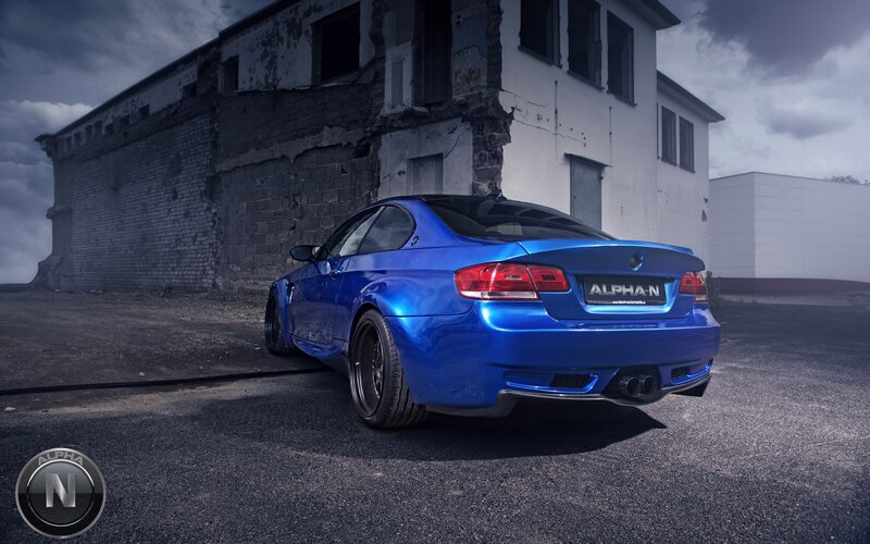 blue car in front of old building