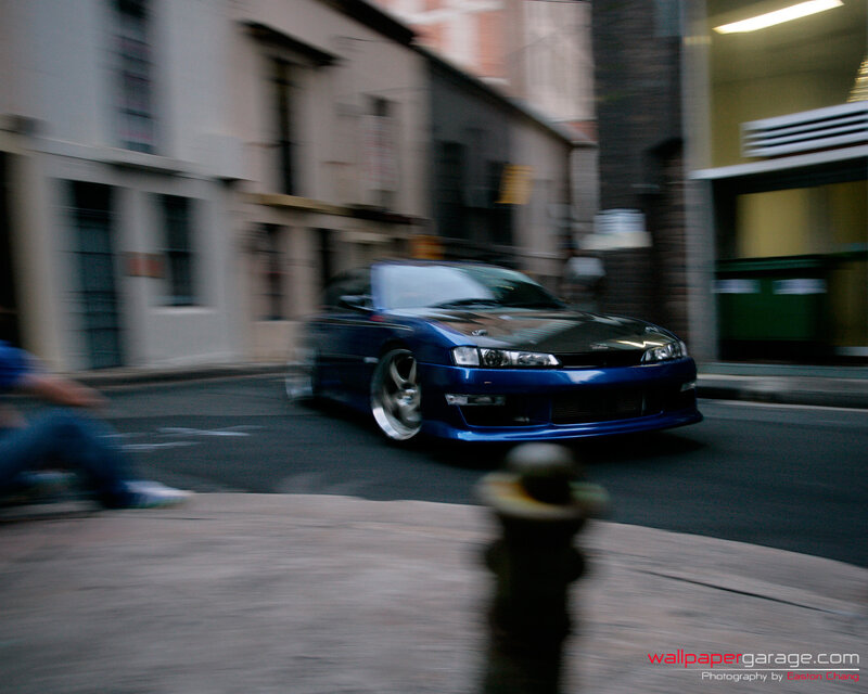 blue car in motion on street