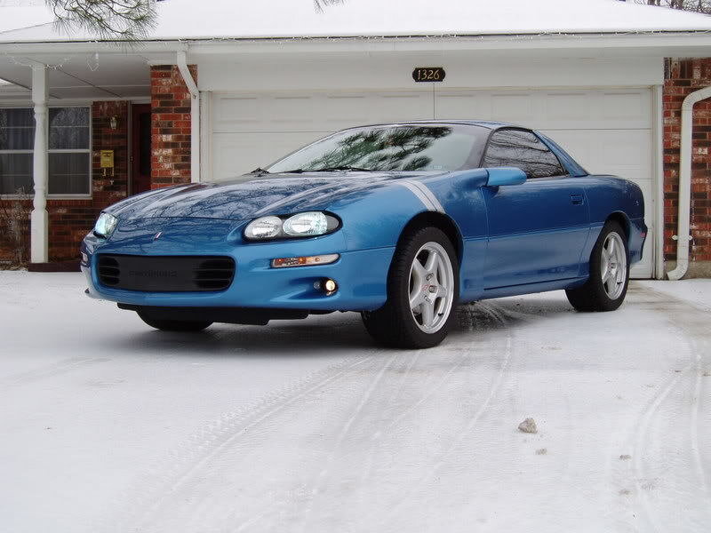 blue car in snowy driveway