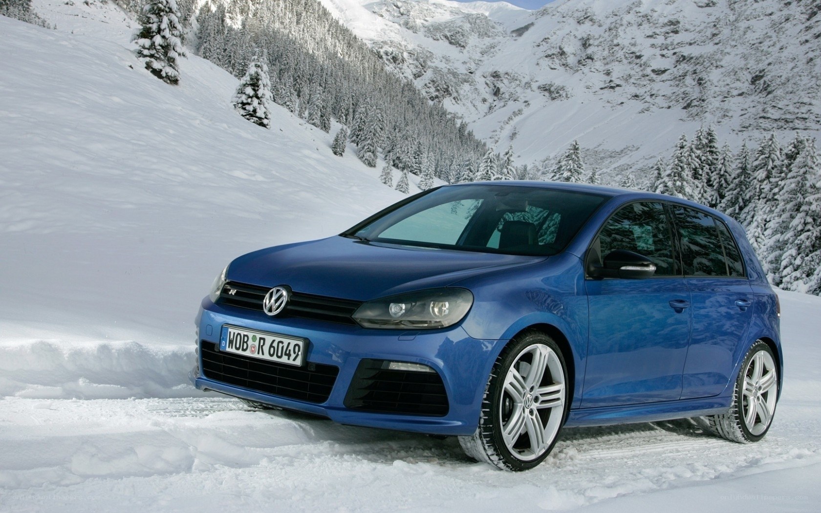 Blue car in snowy mountains