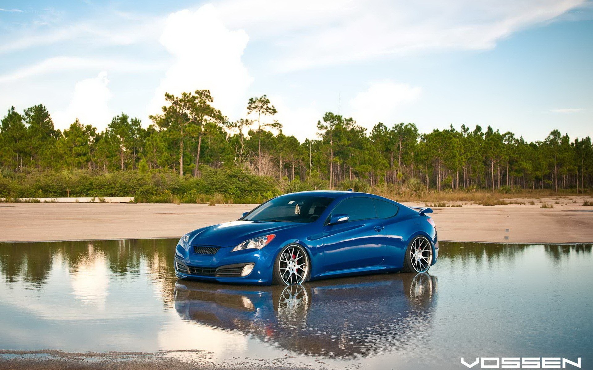 Blue car in water reflection
