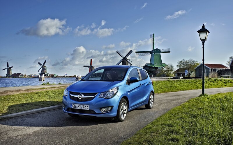 Blue car near windmills