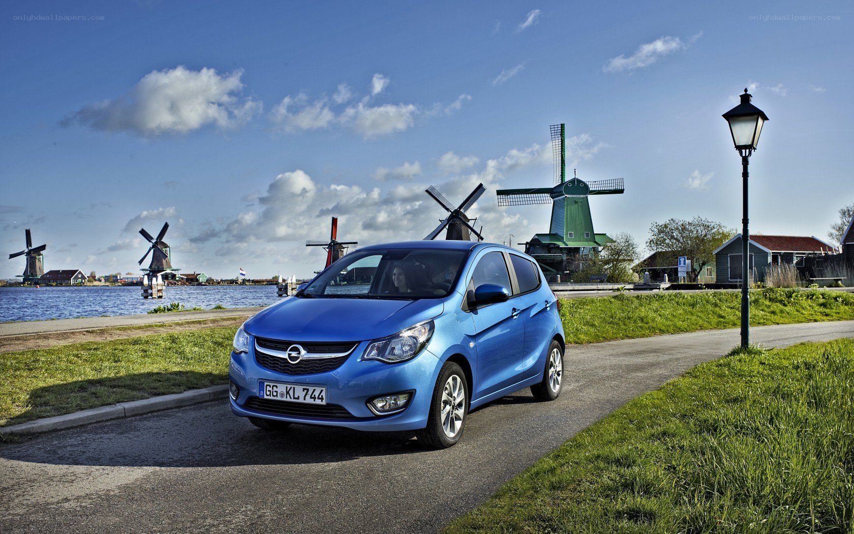 Blue car near windmills