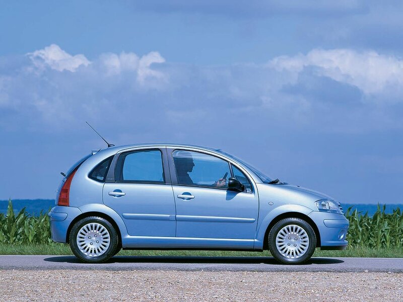 blue car on a country road