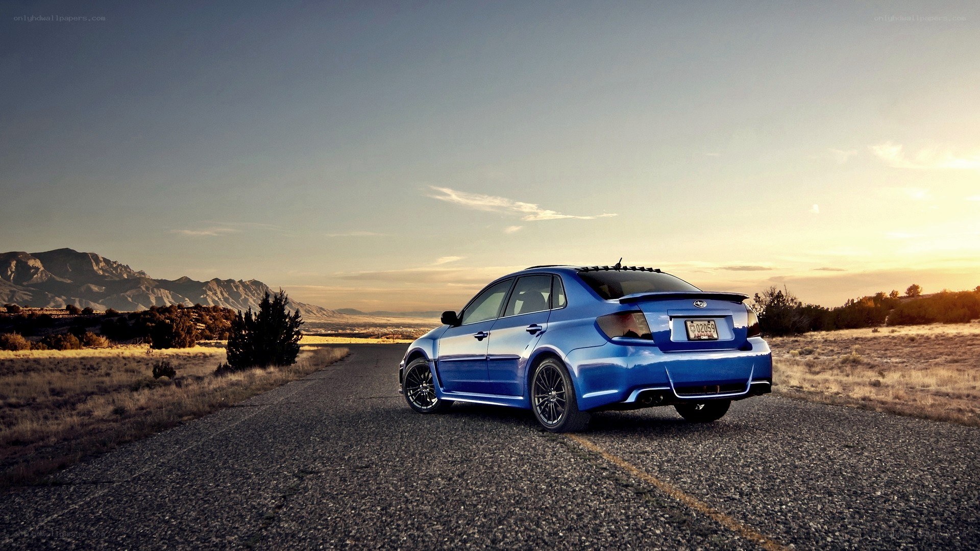 Blue car on a desert road