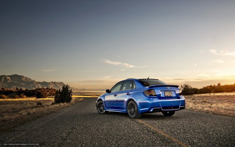 Blue car on a desert road