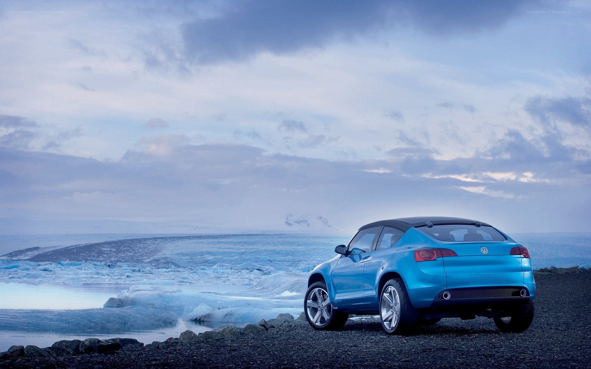 Blue car on a rocky beach