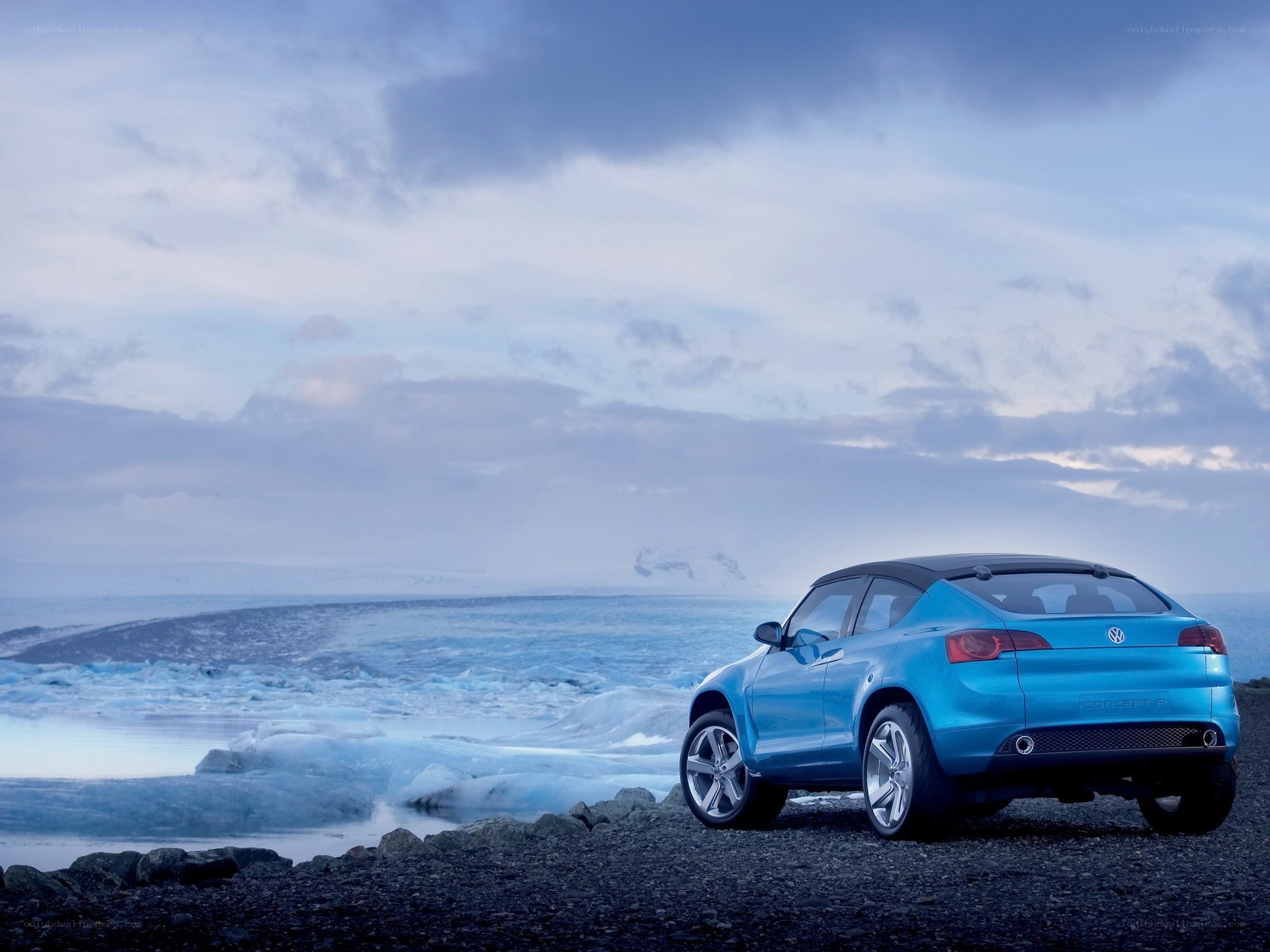 Blue car on a rocky beach