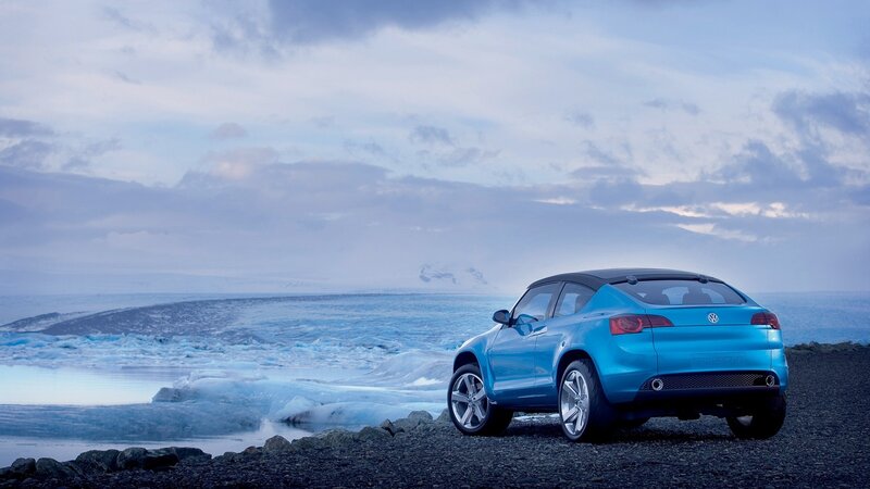 Blue car on a rocky shore