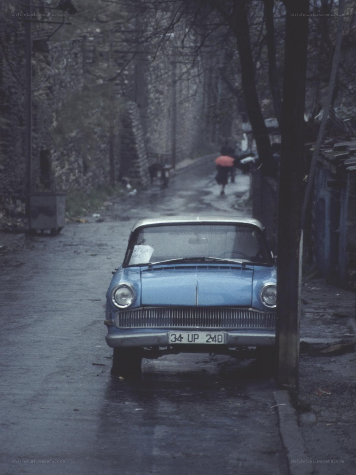 Blue car on a wet street