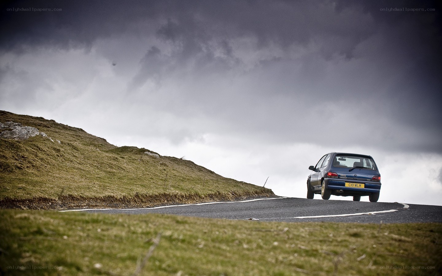 Blue car on a winding road