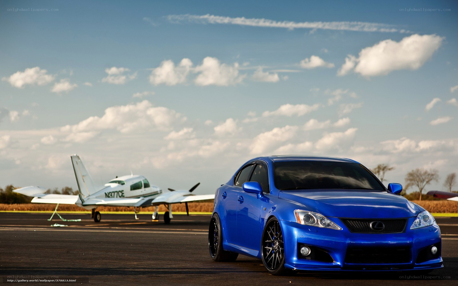 Blue car on airfield with plane