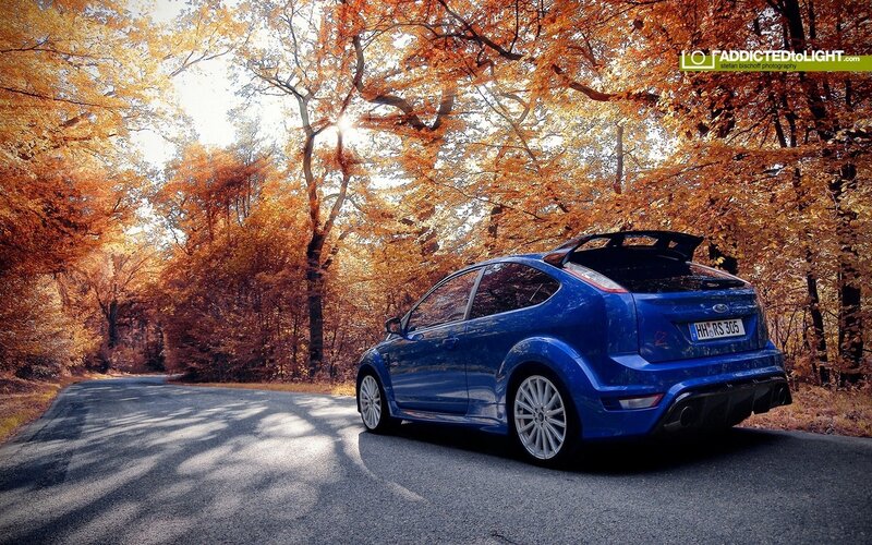 Blue car on autumn road