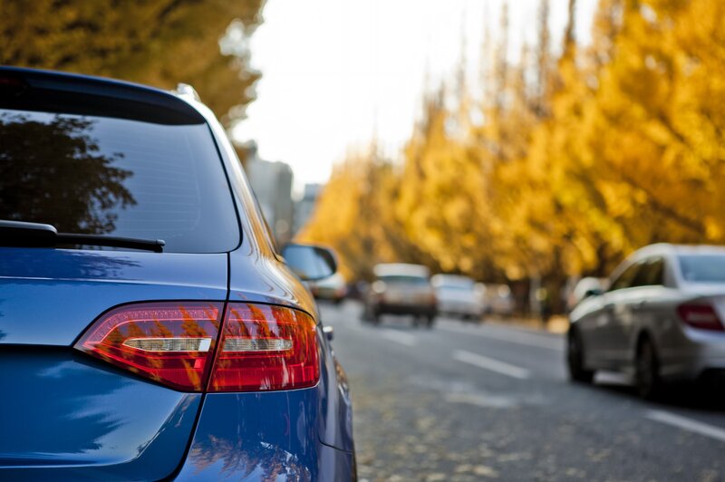 Blue car on autumn street