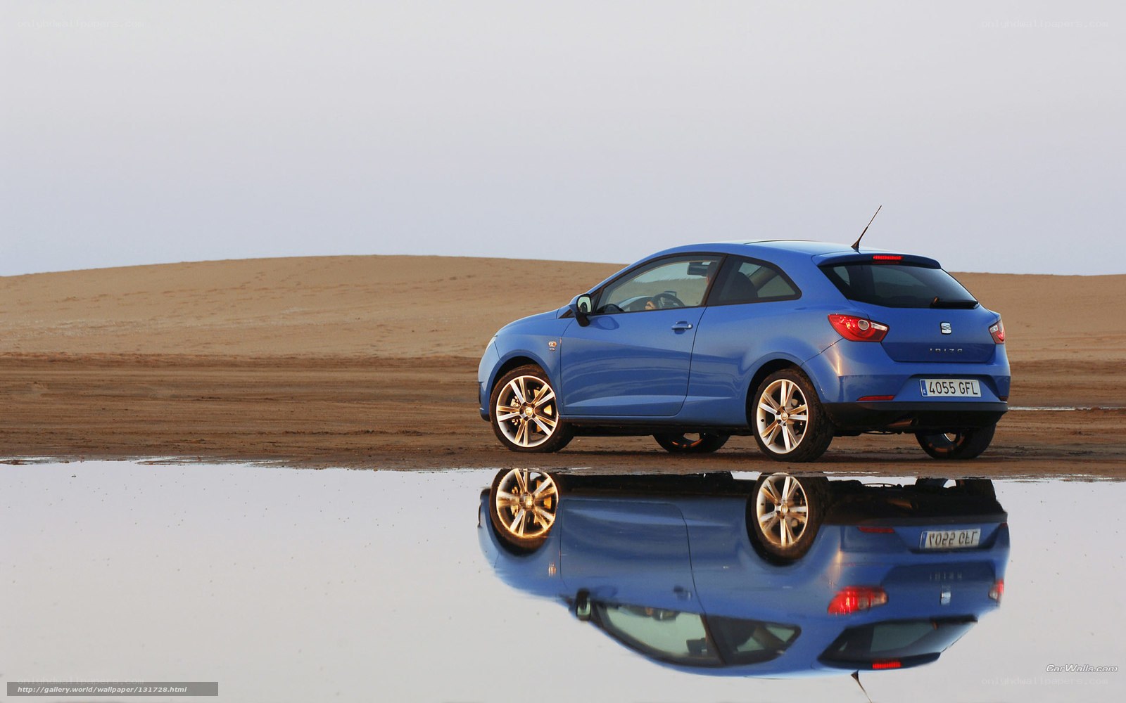 Blue car on beach reflection