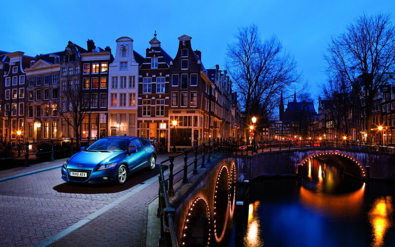 Blue car on canal bridge