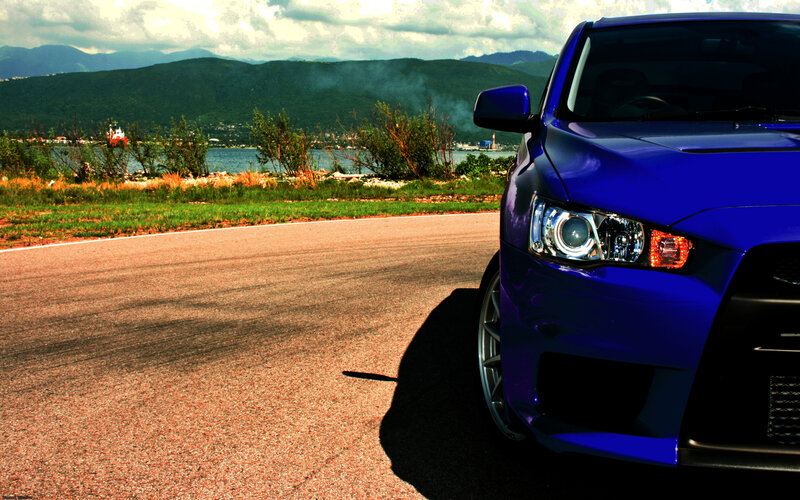 Blue car on coastal road