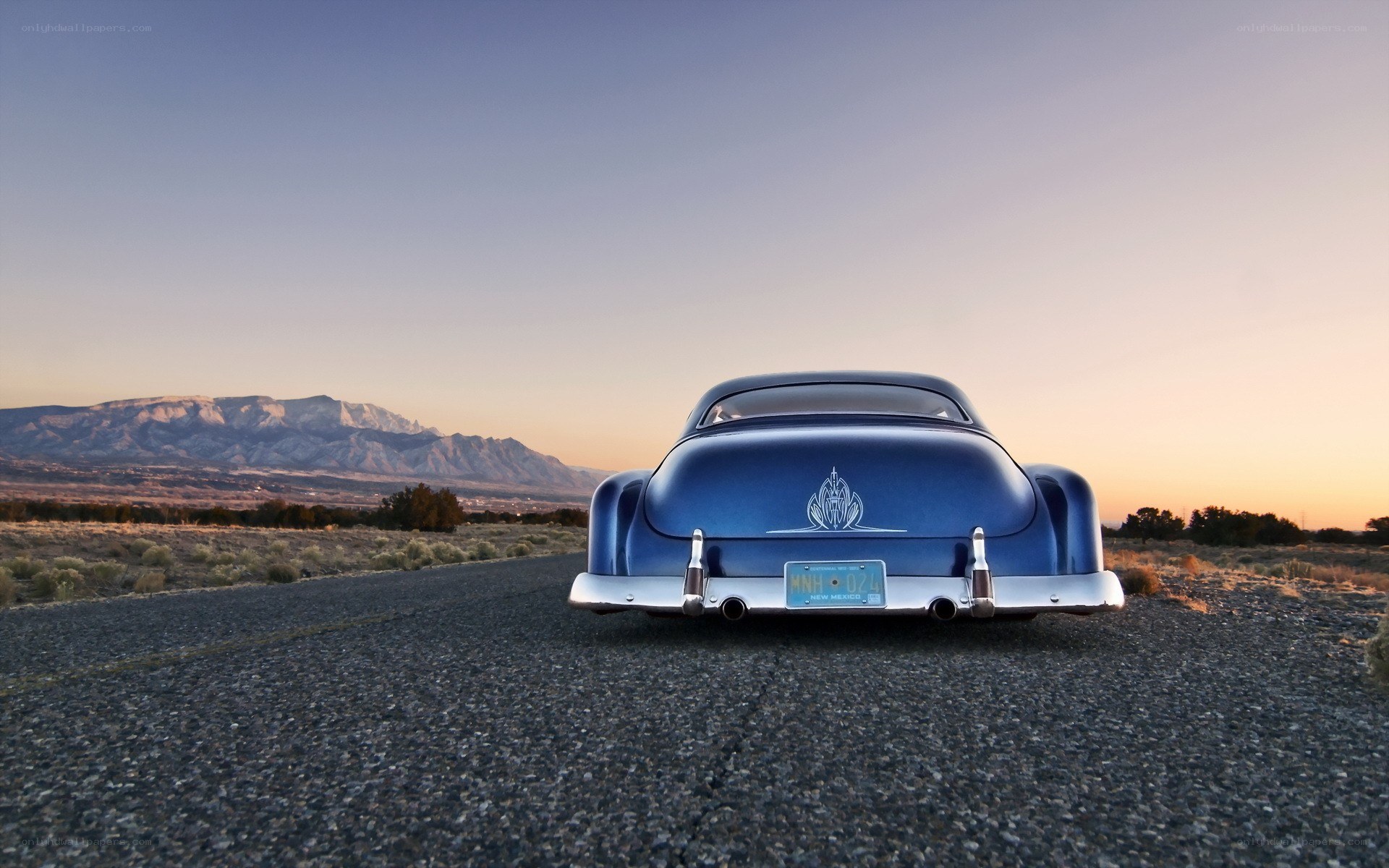 Blue car on desert road
