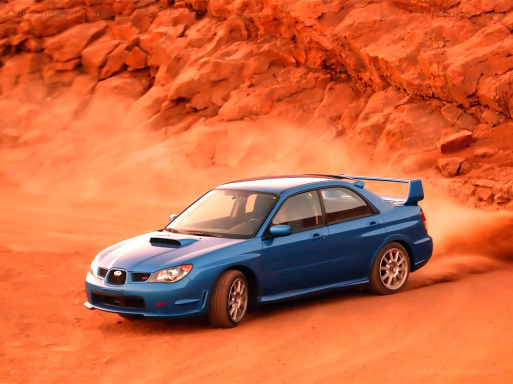 blue car on desert track