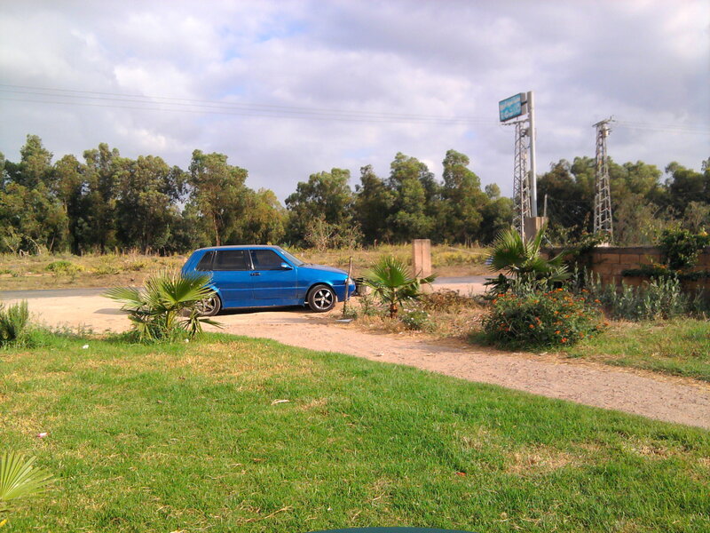 Blue Car on Dirt Path
