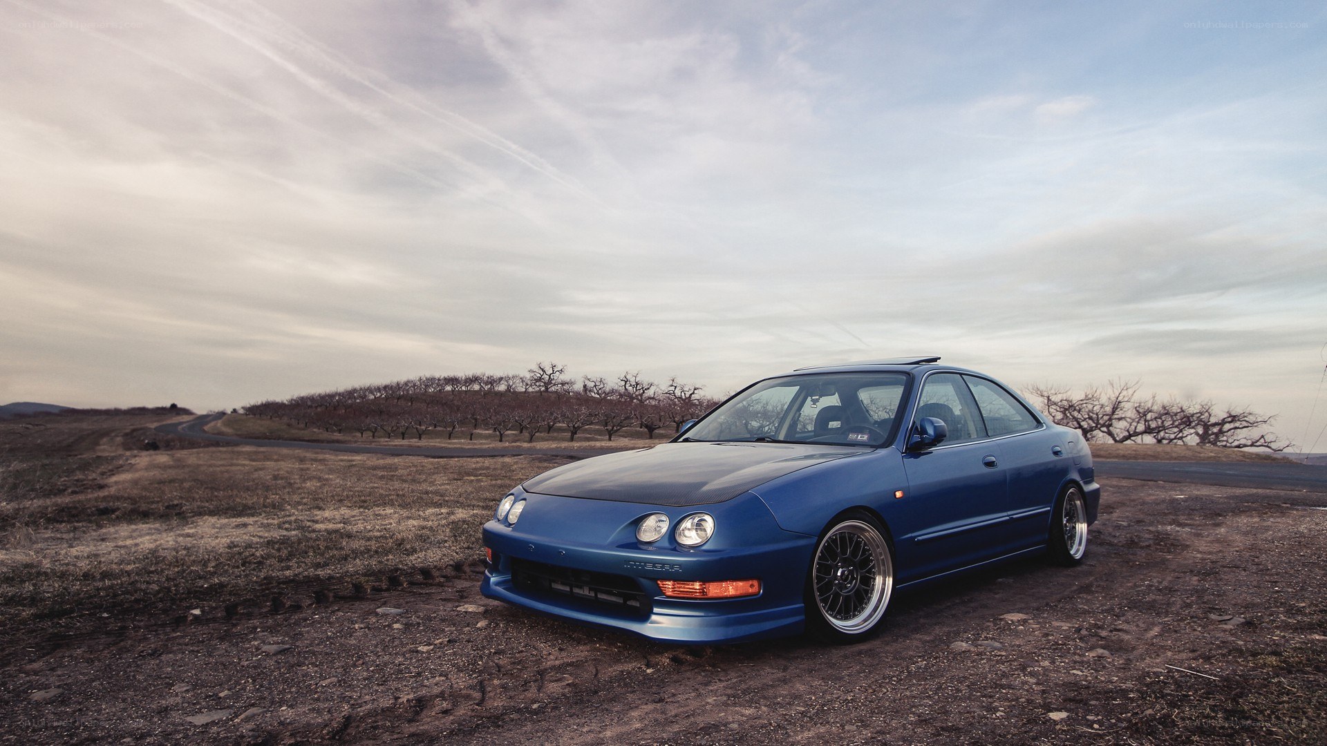 blue car on dirt road