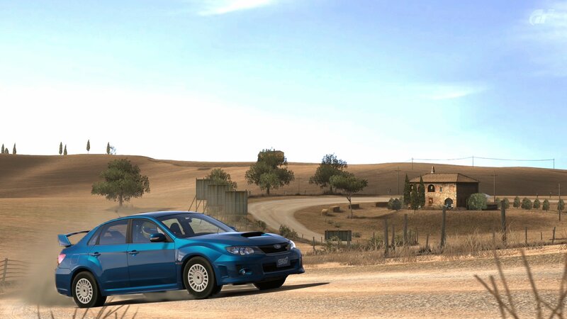 blue car on dirt road