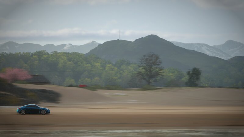 Blue Car on Dirt Road — Brown