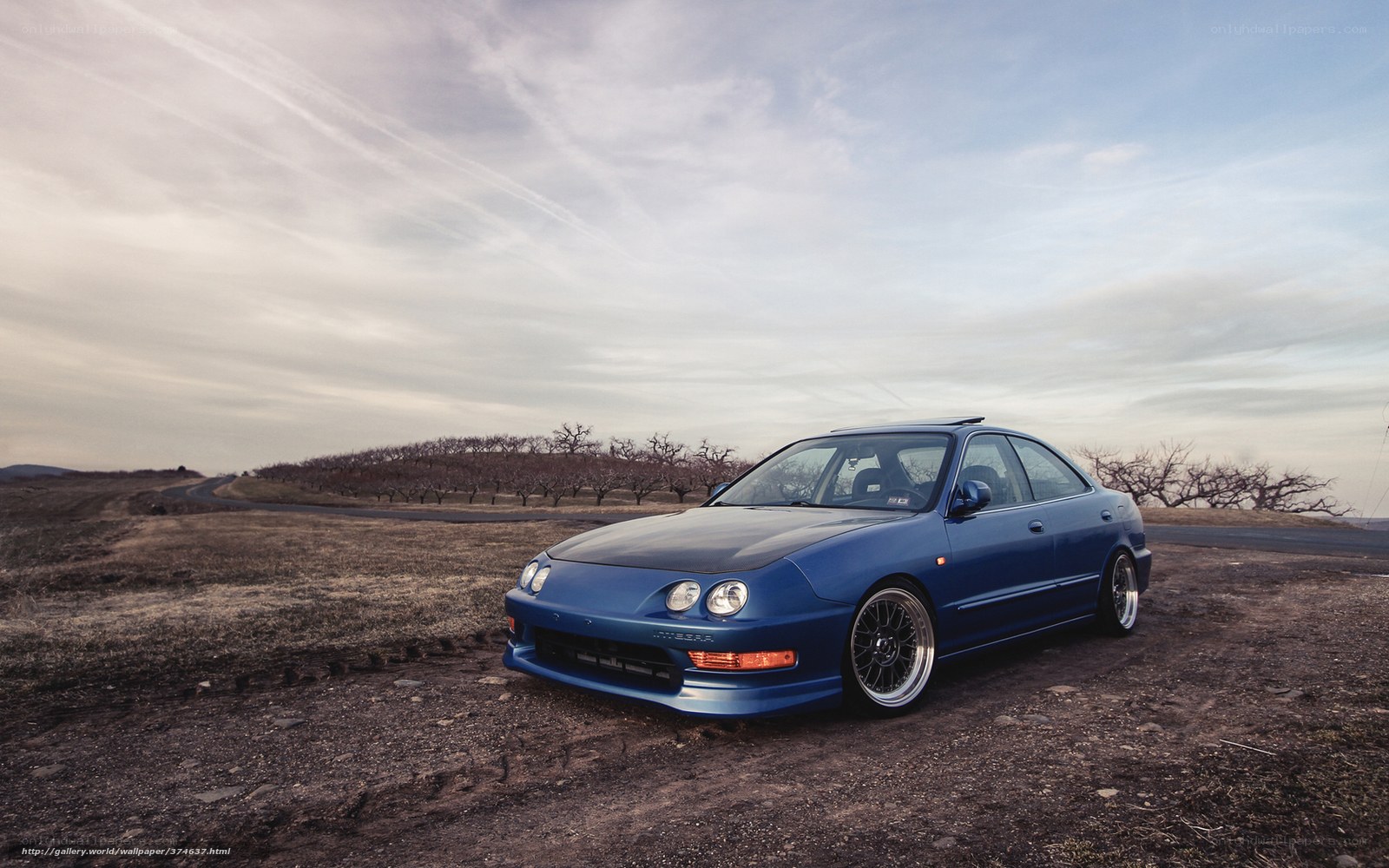 blue car on dirt road