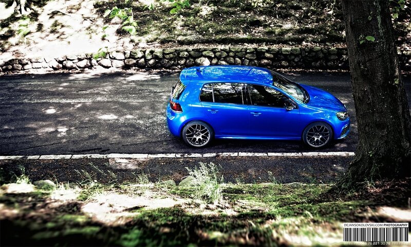 blue car on forest road