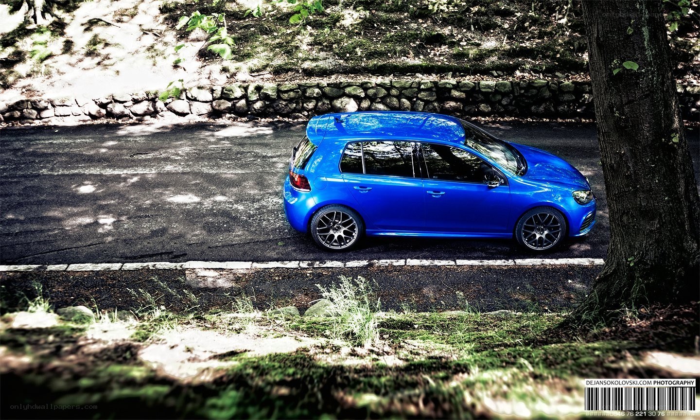 blue car on forest road