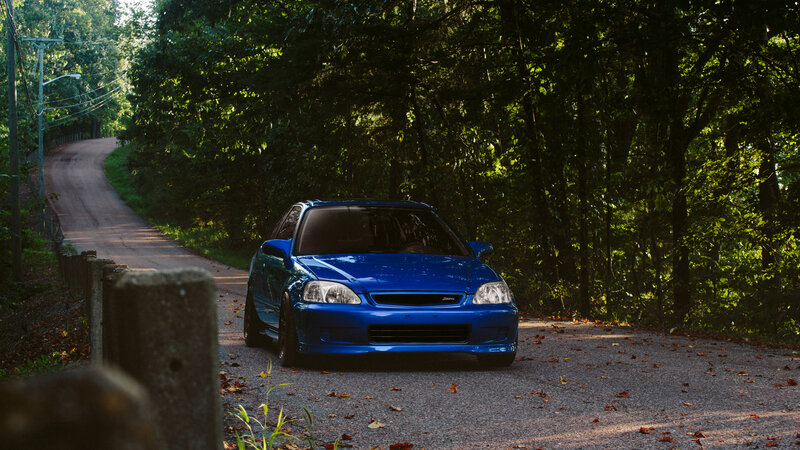 Blue Car on Forest Road — Serene
