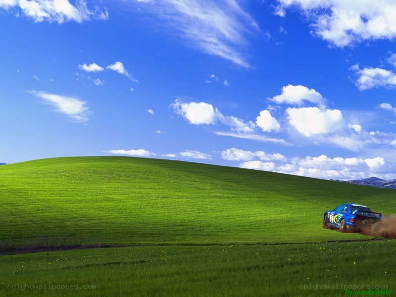 Blue car on green hill