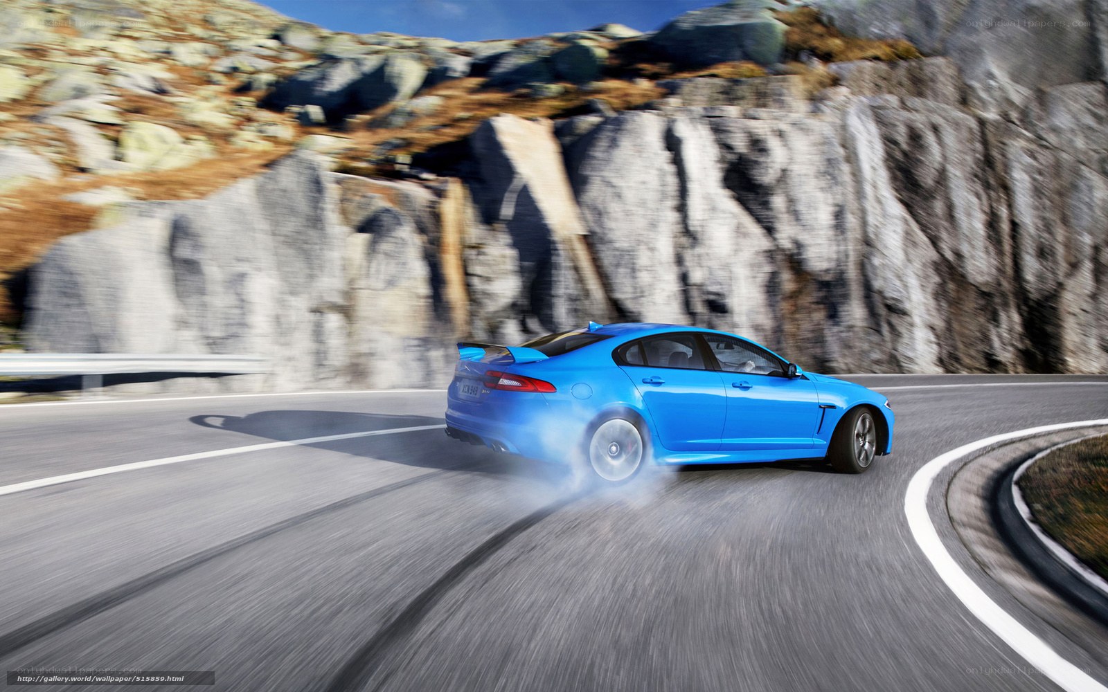 blue car on mountain road