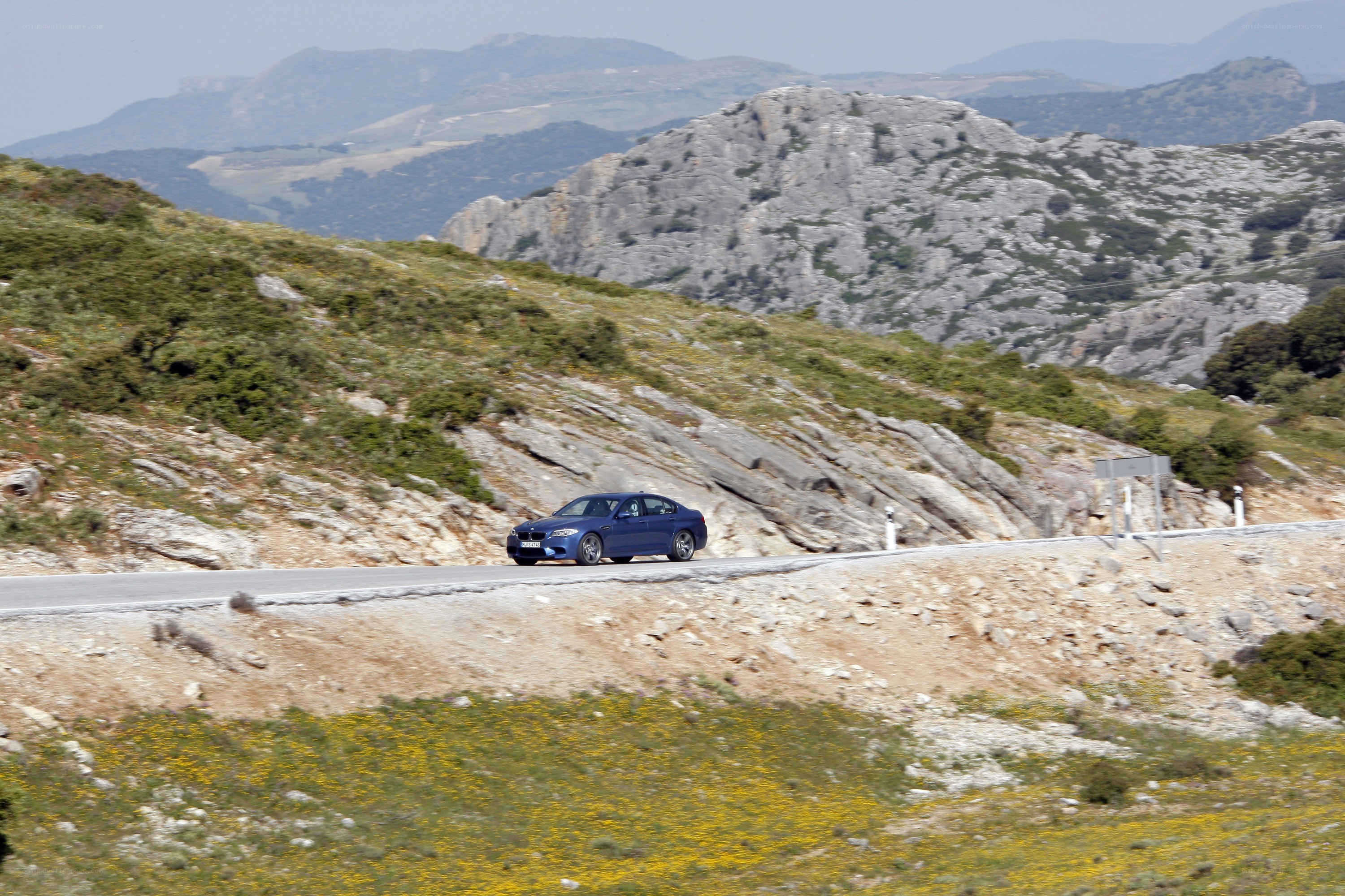 Blue car on mountain road