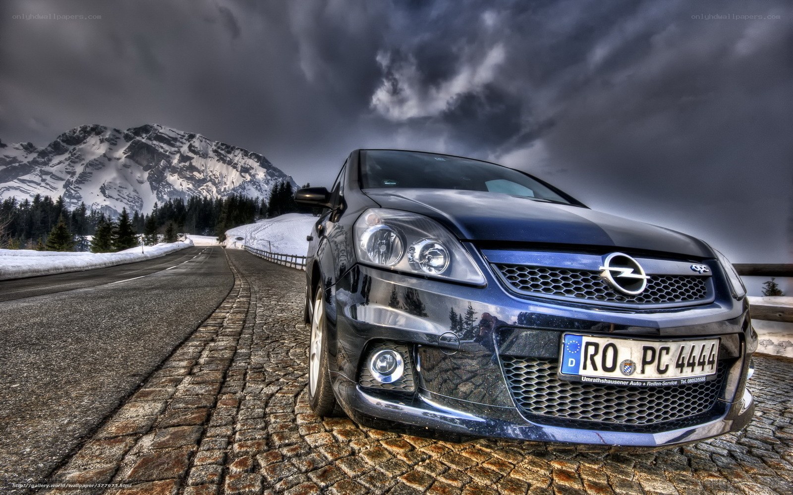 Blue car on mountain road