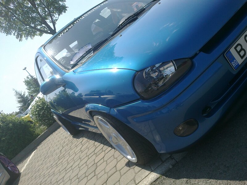 blue car on paved surface