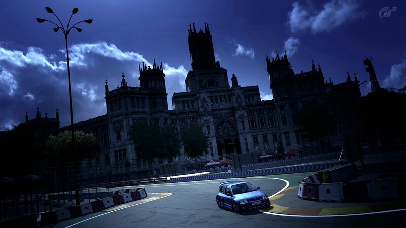 Blue car on race track at night