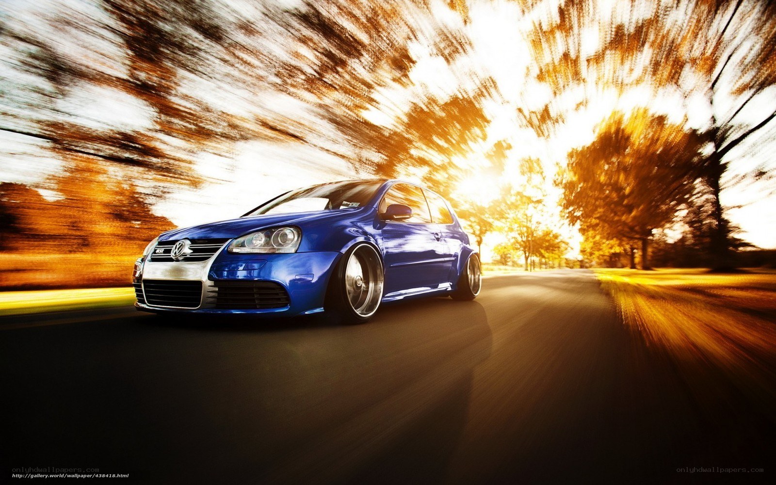 blue car on road at sunset