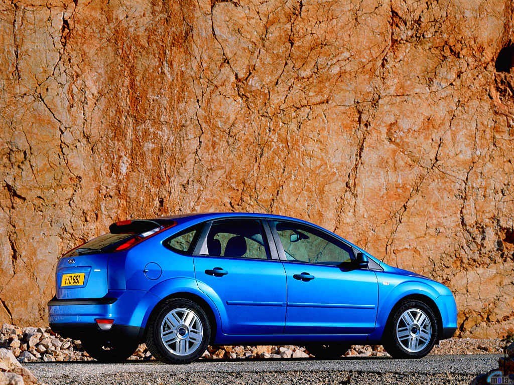 blue car on rocky road