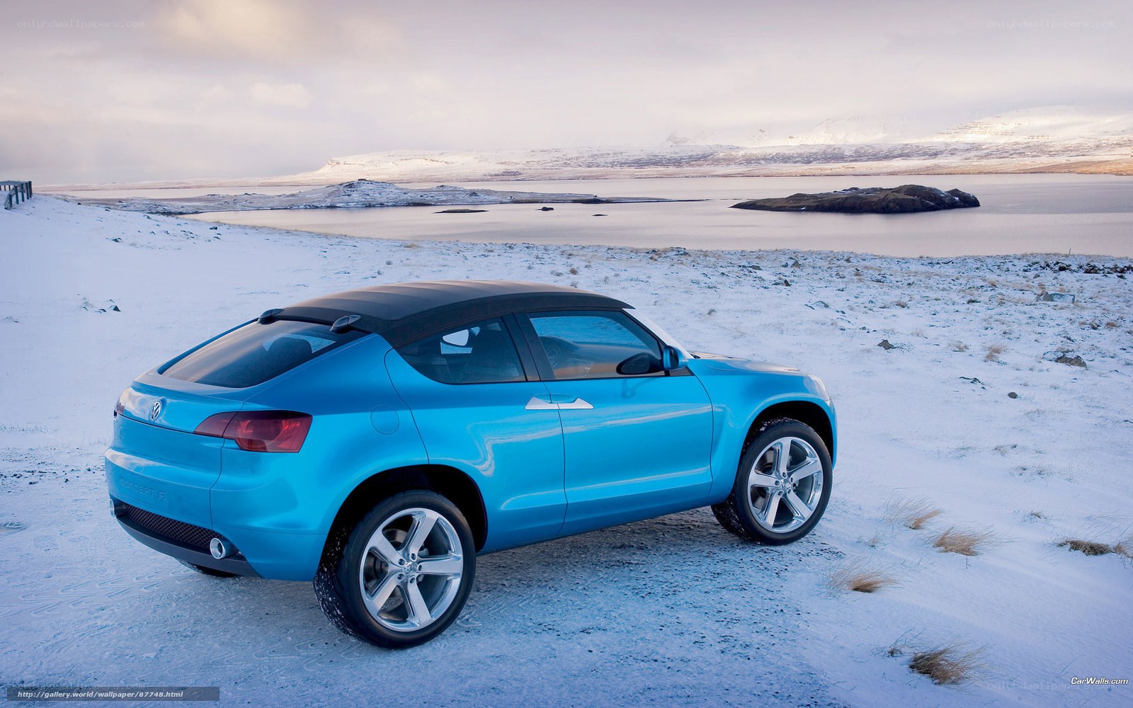 Blue car on snowy landscape