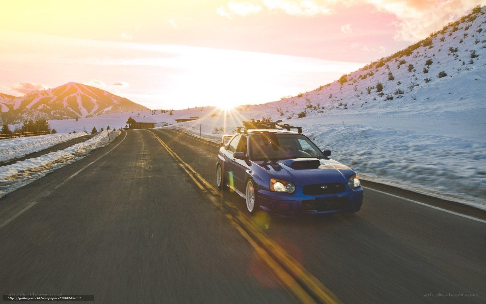 blue car on snowy mountain road