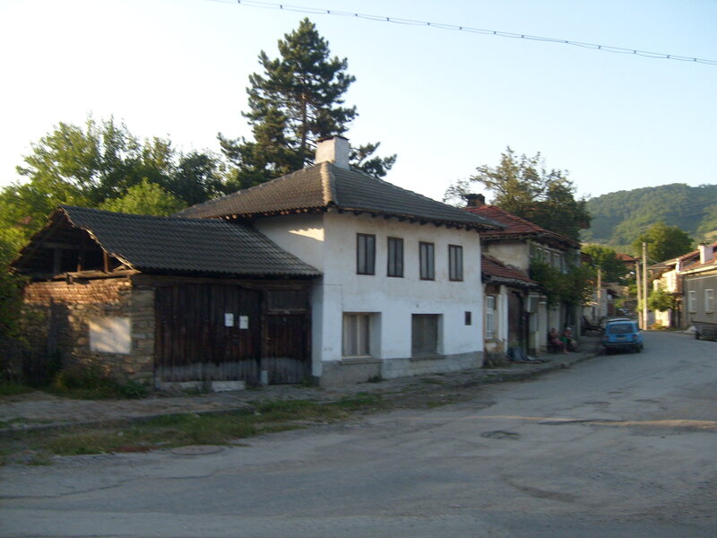 Blue Car on Village Street