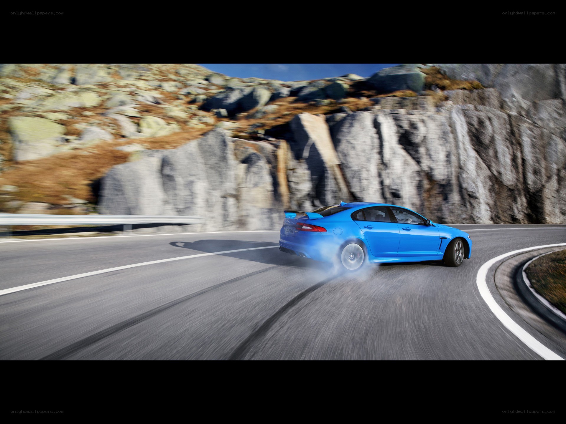 blue car on winding road